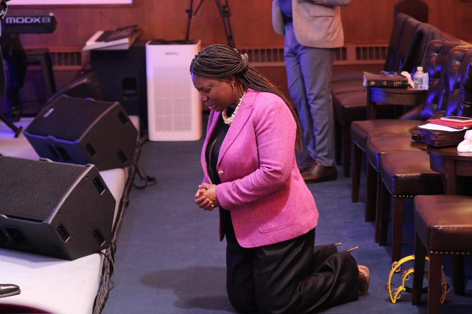 Kneeling in prayer at the front of the sanctuary